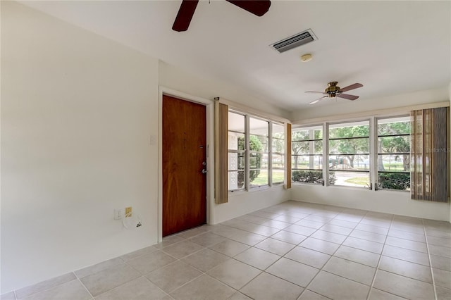 unfurnished sunroom with ceiling fan