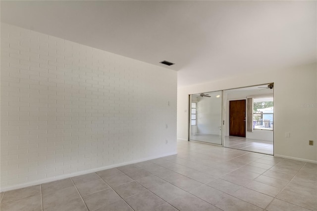 empty room featuring ceiling fan and light tile patterned flooring