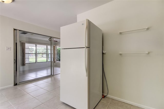 kitchen featuring white refrigerator and light tile patterned floors