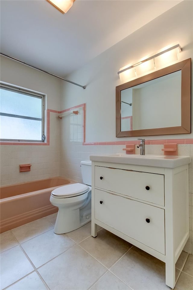 full bathroom featuring tile patterned floors, vanity, tile walls, and toilet