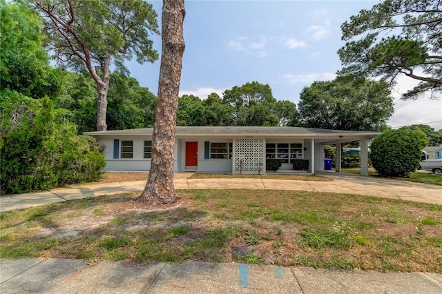 ranch-style house featuring a carport