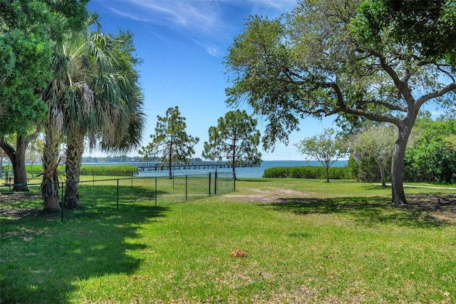 view of property's community with a yard and a water view