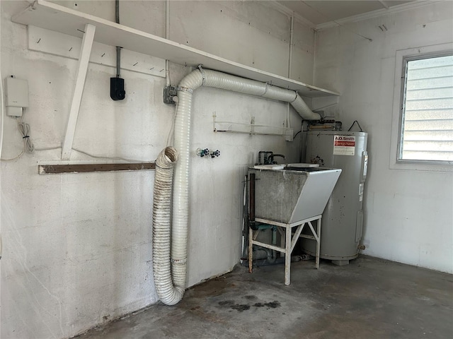 utility room featuring electric water heater and sink