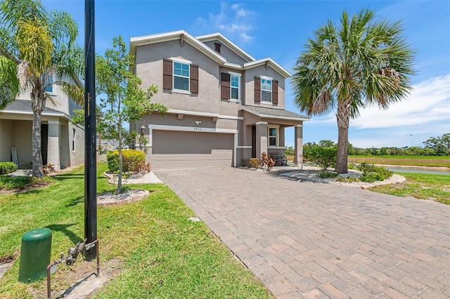 view of front of home with a garage and a front lawn