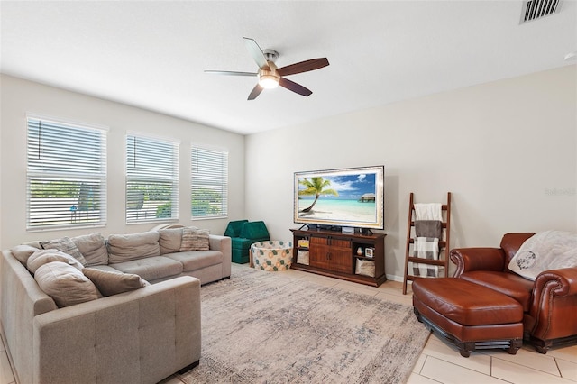 tiled living room with ceiling fan