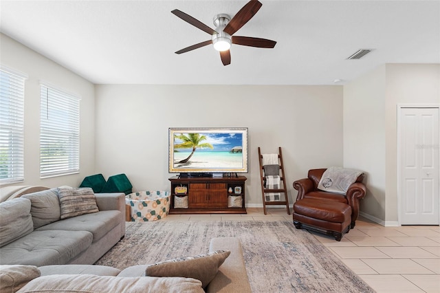 living room featuring ceiling fan and light tile patterned floors