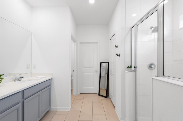 bathroom with a shower with door and vanity