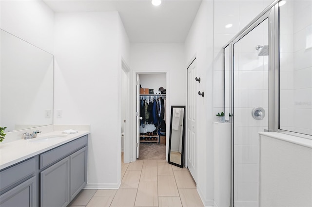 bathroom featuring vanity and an enclosed shower