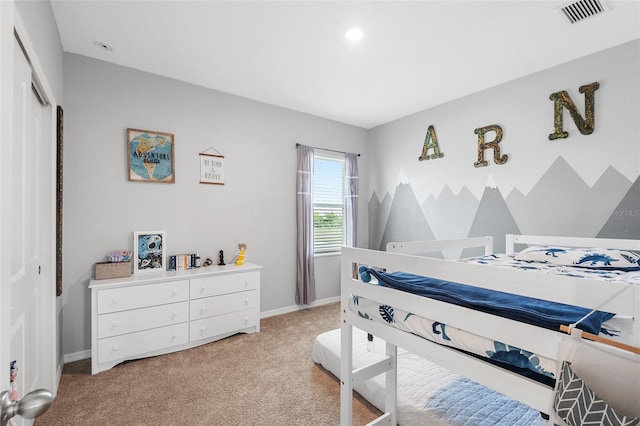 bedroom with light colored carpet and a closet