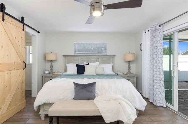 bedroom with a barn door, access to outside, and ceiling fan