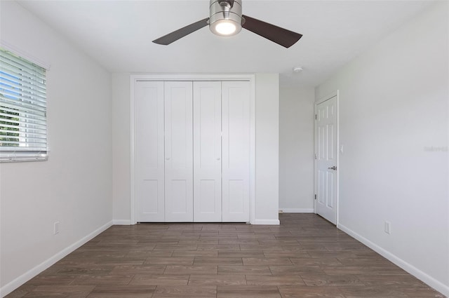 unfurnished bedroom featuring dark hardwood / wood-style flooring, a closet, and ceiling fan