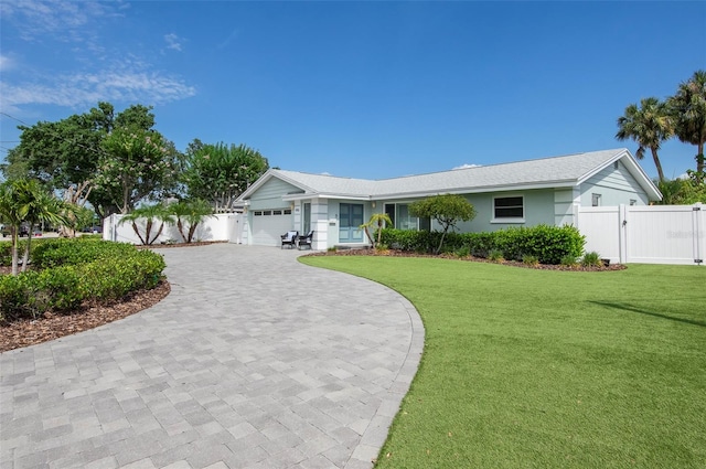 ranch-style home with a garage and a front yard