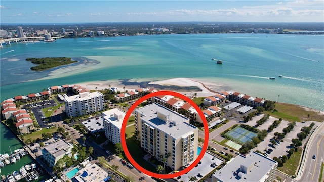 drone / aerial view with a beach view and a water view