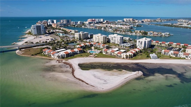 birds eye view of property with a water view and a beach view