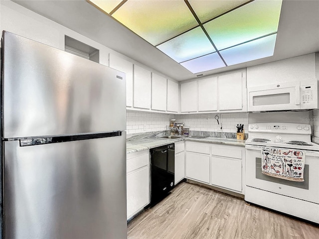 kitchen with white cabinetry, white appliances, decorative backsplash, and light wood-type flooring