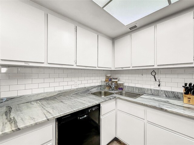 kitchen featuring white cabinets, decorative backsplash, black dishwasher, and sink