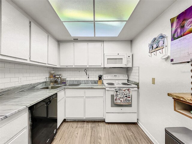 kitchen featuring sink, white appliances, white cabinetry, light hardwood / wood-style floors, and decorative backsplash