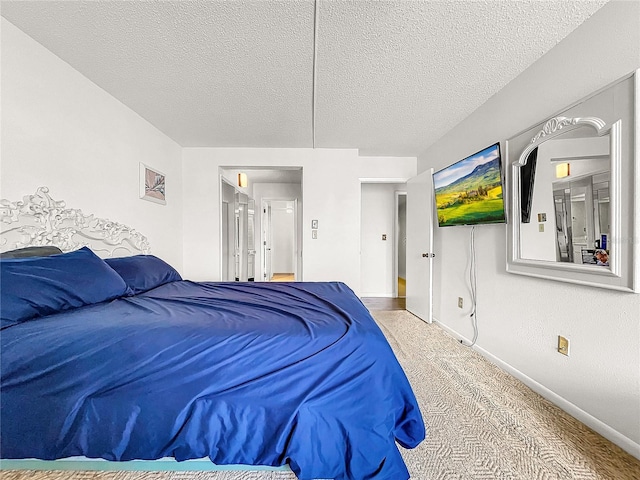 bedroom featuring carpet and a textured ceiling