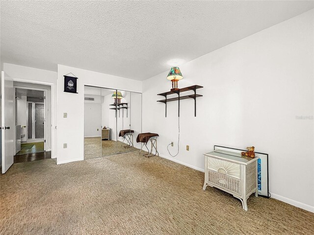 spare room with carpet flooring and a textured ceiling