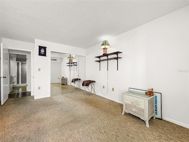 unfurnished room featuring carpet floors and a textured ceiling