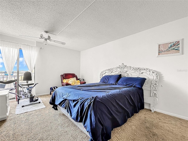 bedroom featuring carpet, a textured ceiling, and ceiling fan