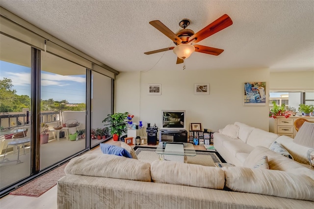 living room with a textured ceiling, light hardwood / wood-style flooring, and ceiling fan