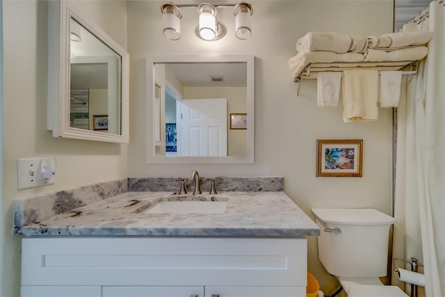 bathroom with vanity and toilet