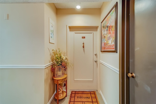 entryway with a textured ceiling and tile patterned floors