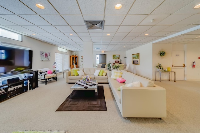 carpeted living room featuring a paneled ceiling