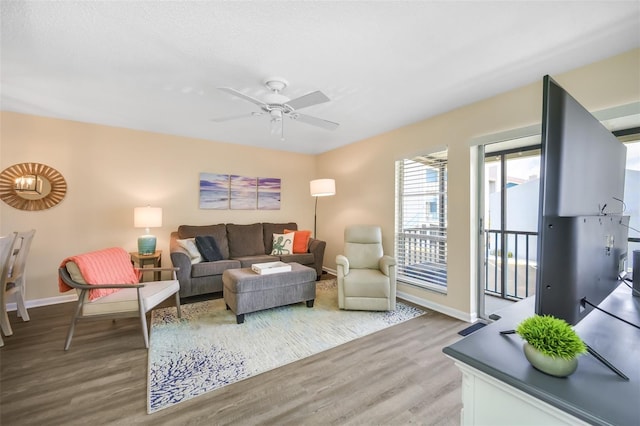 living room featuring ceiling fan and light hardwood / wood-style flooring