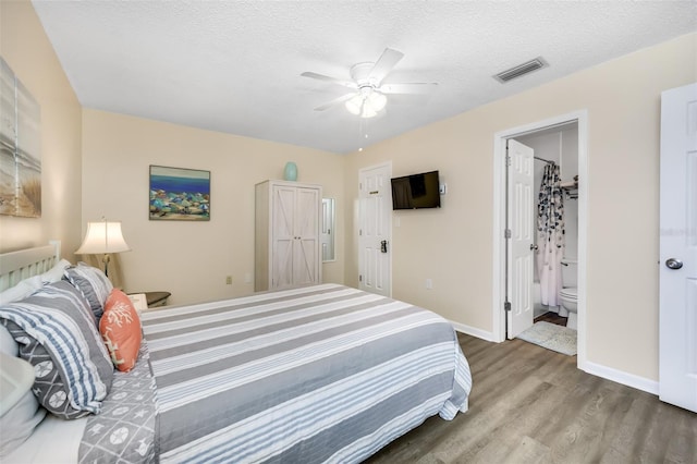 bedroom featuring connected bathroom, ceiling fan, hardwood / wood-style floors, a textured ceiling, and a closet