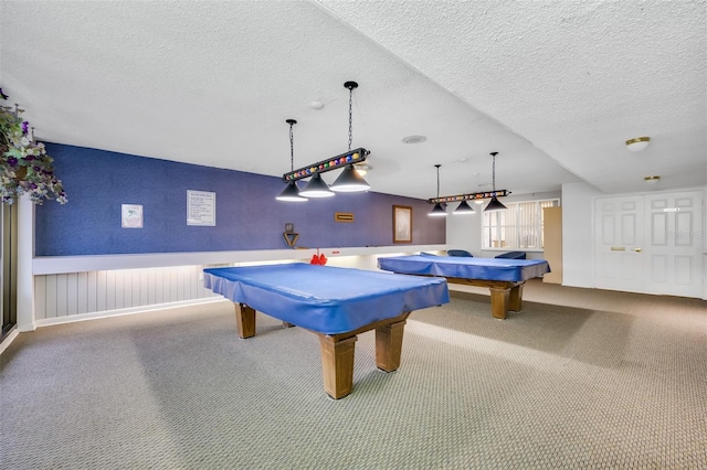 recreation room with carpet, a textured ceiling, and pool table