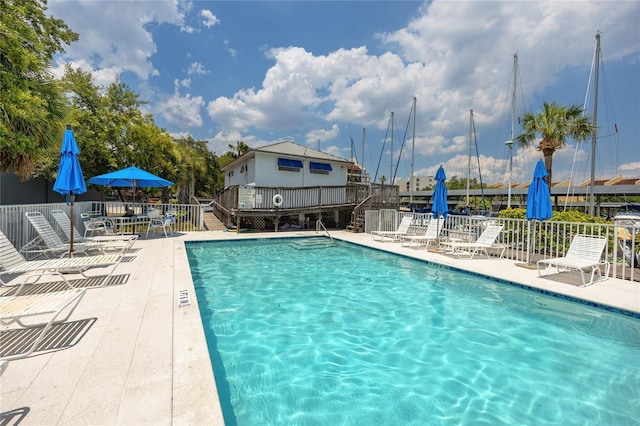 view of swimming pool with a patio area and a wooden deck