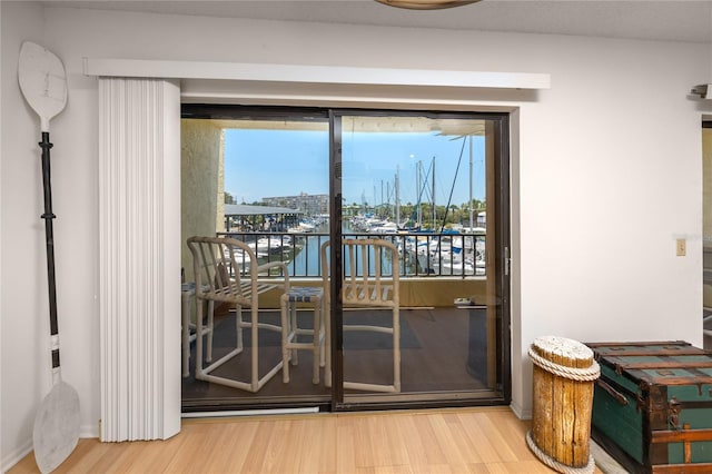 doorway to outside featuring a water view and hardwood / wood-style flooring