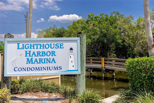 community sign featuring a water view