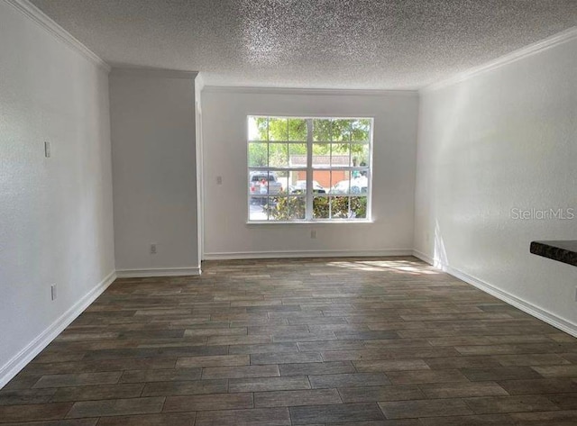 spare room featuring dark wood-type flooring, a textured ceiling, and ornamental molding