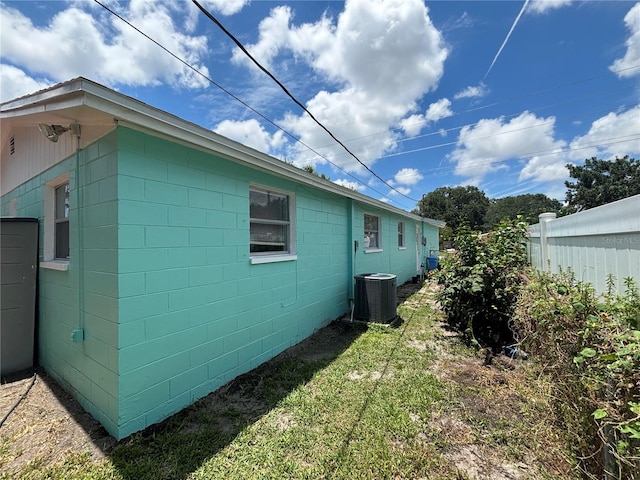 view of property exterior featuring a lawn and central AC unit