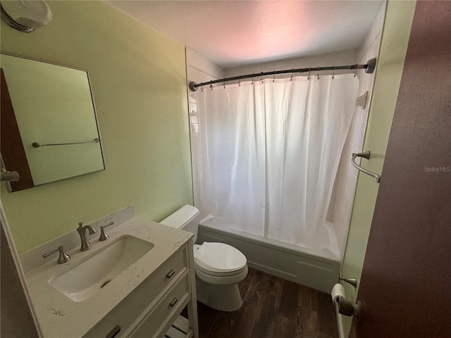 full bathroom with hardwood / wood-style floors, vanity, toilet, and shower / tub combo with curtain