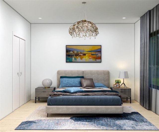 sitting room with light wood-type flooring and an inviting chandelier