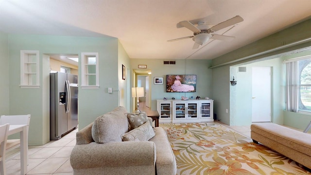 living room featuring light tile patterned floors and ceiling fan