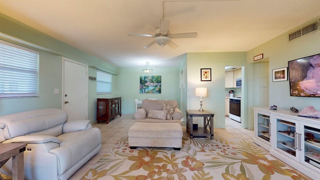 tiled living room featuring ceiling fan