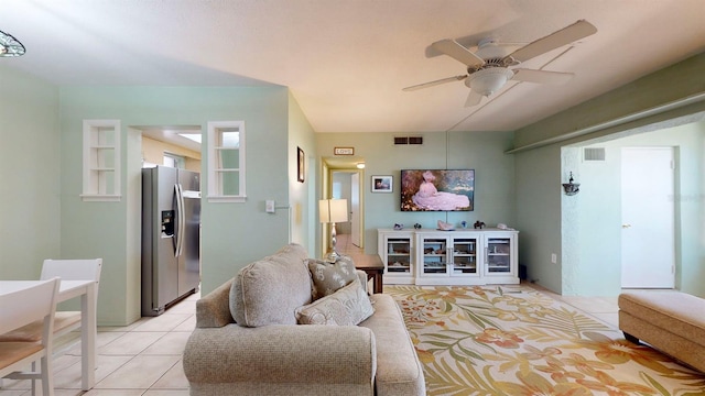 living room featuring ceiling fan and light tile patterned floors