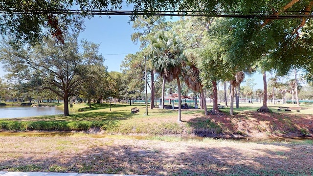 view of property's community with a lawn, a gazebo, and a water view