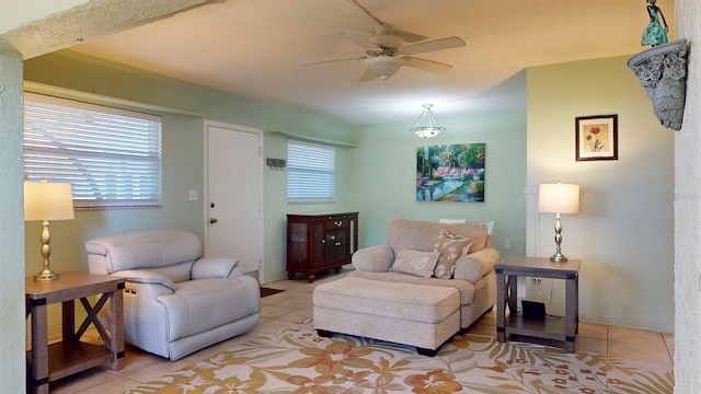 living room featuring a wealth of natural light, ceiling fan, and light tile patterned flooring