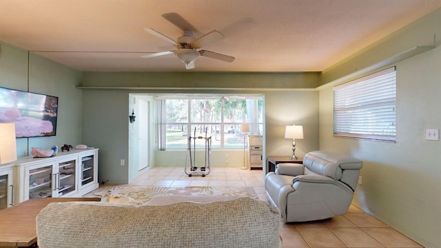 living room featuring ceiling fan and light tile patterned flooring