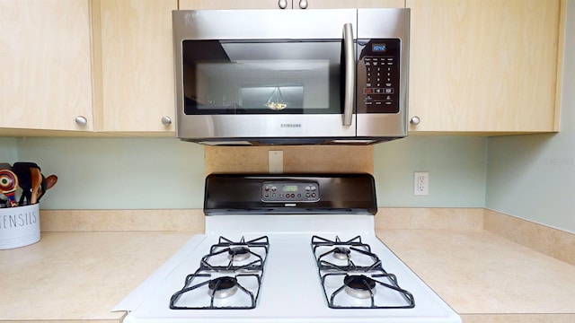 kitchen featuring light brown cabinetry and gas range