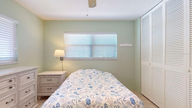 bedroom with ceiling fan and a closet