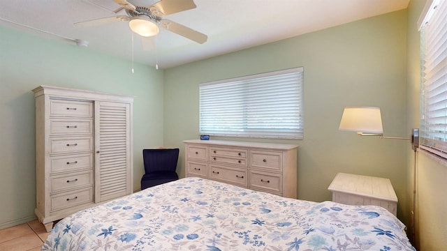 bedroom featuring ceiling fan and light tile patterned floors