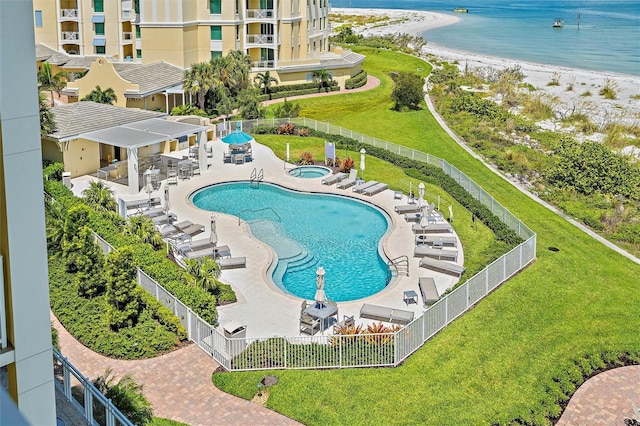 view of swimming pool with a beach view, a patio, and a water view