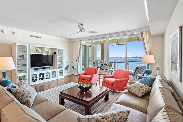 living room with hardwood / wood-style floors, ceiling fan, floor to ceiling windows, and ornamental molding